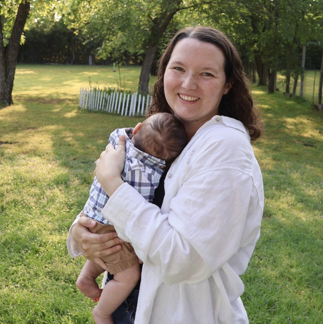 Mother holding baby son outside
