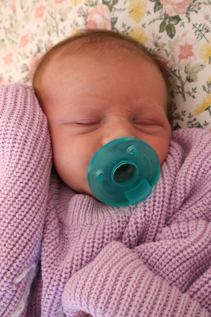 Baby girl sleeping with pacifier
